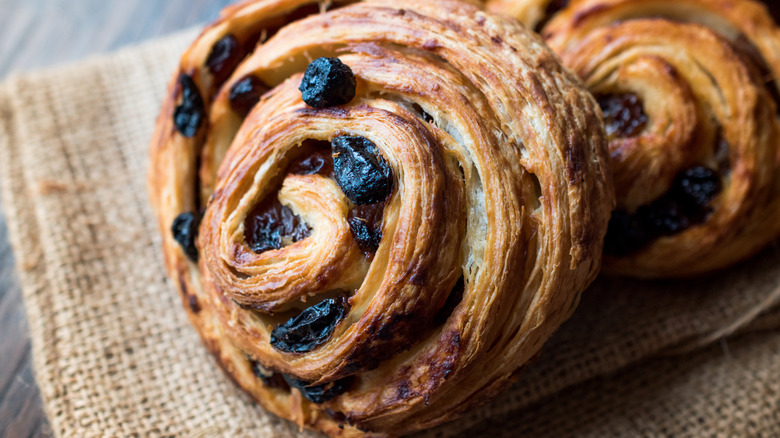 Two raisin schnecken on burlap cloth