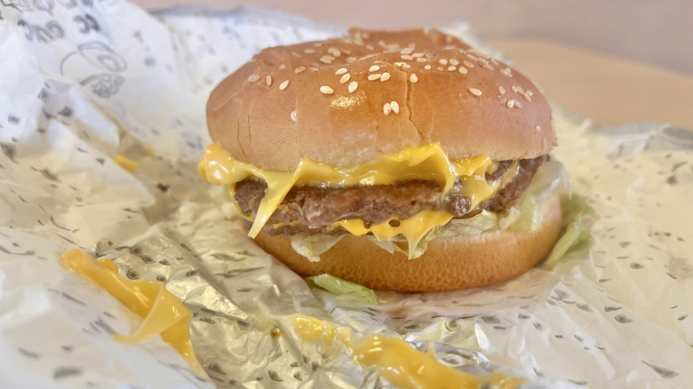 Side view of a messy cheeseburger