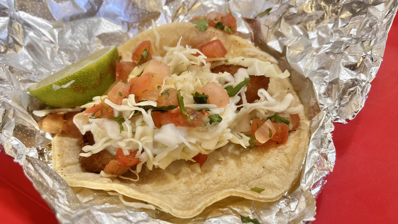 Fish taco with cabbage and tomato