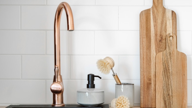 A simple, copper sink faucet in a kitchen.