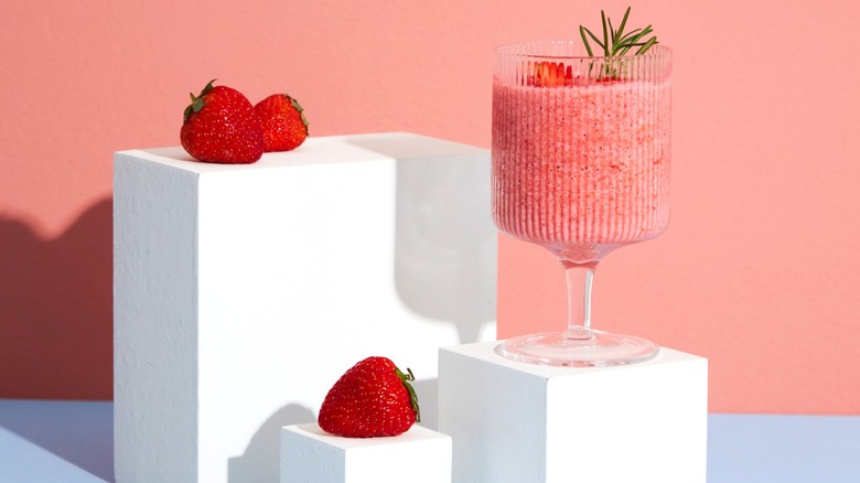 strawberry smoothie on pink background