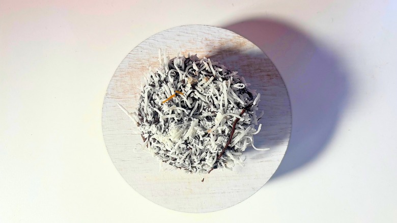 Voodoo Doughnut Chocolate Coconut donut on white table