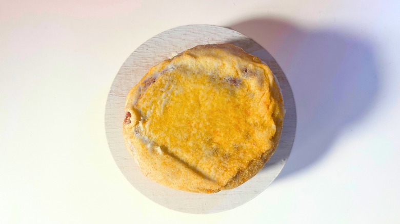 Voodoo Doughnut Mango Tango donut on white table