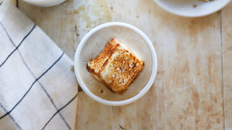 Latte in mug topped with toasted marshmallow
