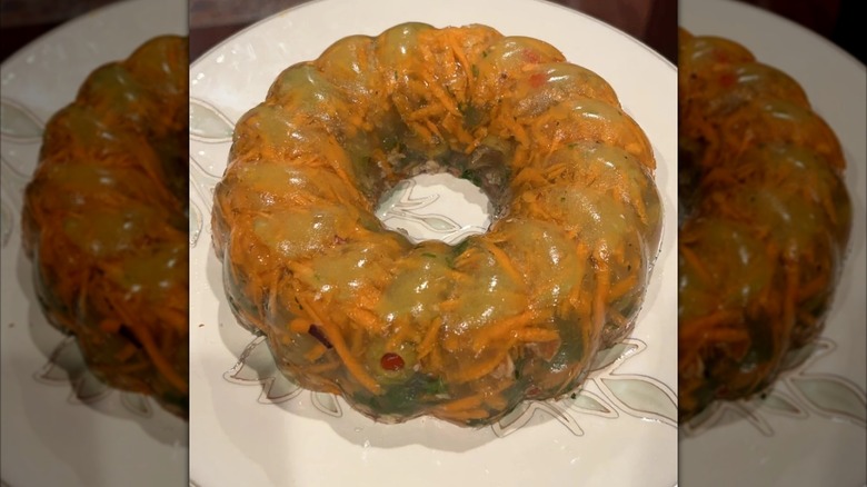 Mirrored image of savory gelatine salad on a patterned white plate