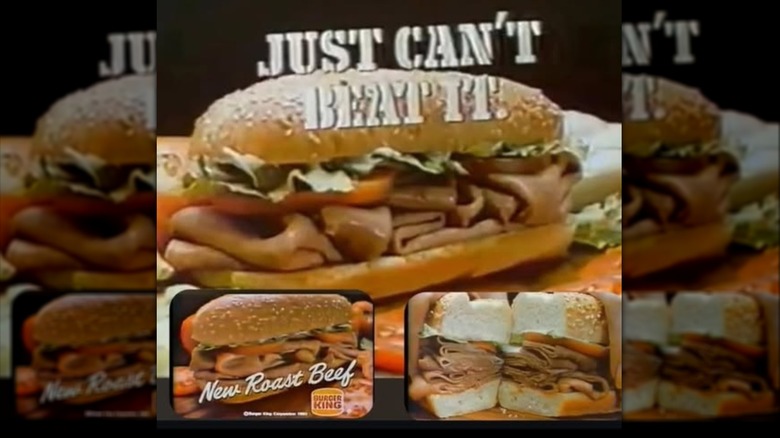 Roast beef sandwich on a hoagie salad bun with lettuce tomato and mayo. There are potato chips in the background