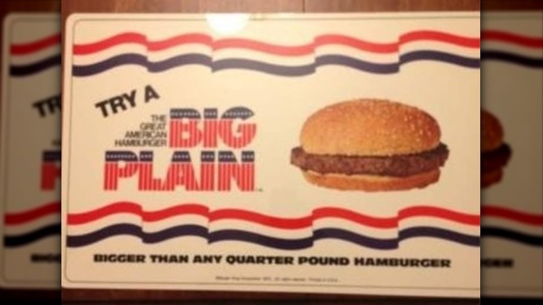 An ad for a Burger King Big Plain featuring a toppingless burger advertised with patriotic colors and text