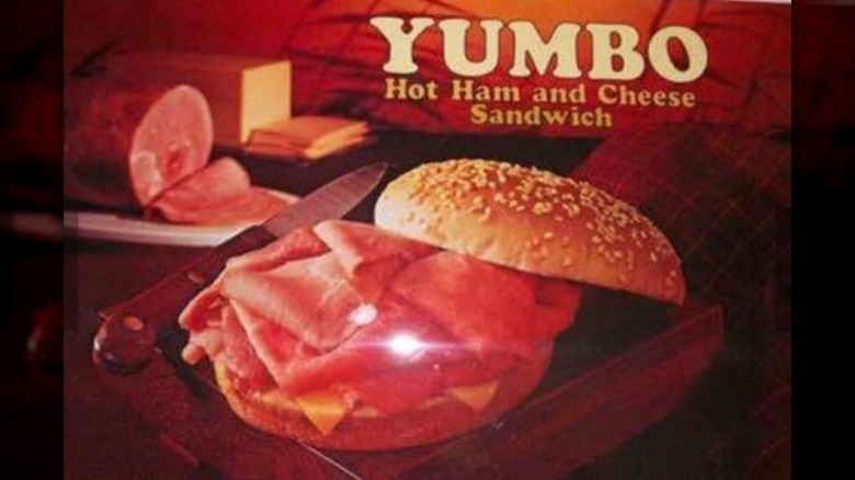 A Burger King Yumbo sandwich featuring slices of deli ham and cheese on a sesame seed bun