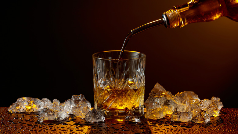 bourbon whiskey poured into crystal glass