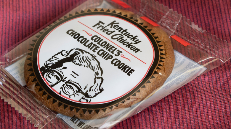 KFC chocolate chip cookie inside plastic packet on red surface