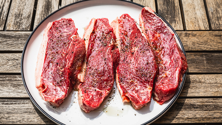 Uncooked picanha steaks on plate