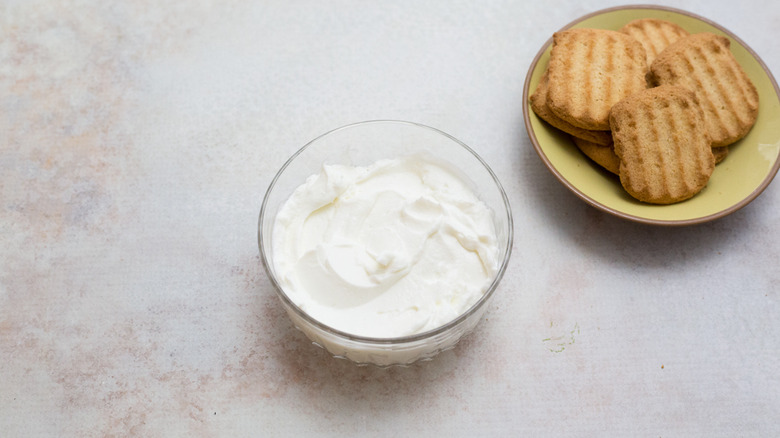 yogurt and cookies on table