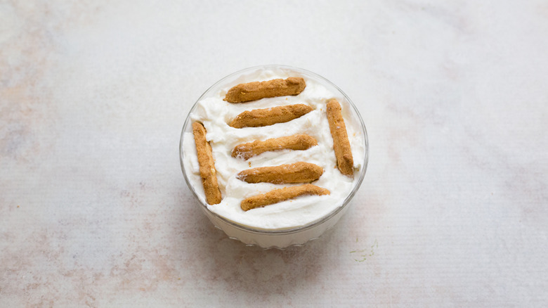 yogurt with cookies on table