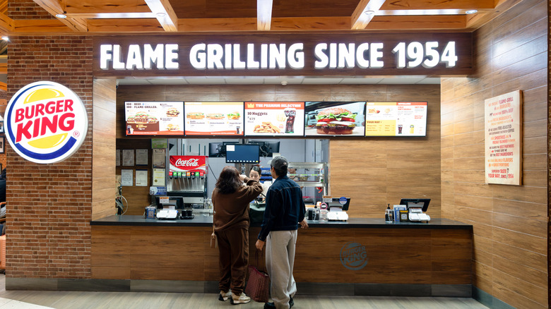 People ordering inside of a Burger King