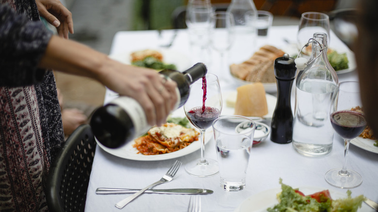 Red wine being poured at table