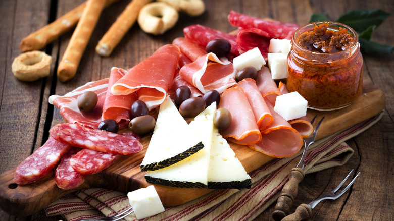 cured meats and cheeses on a board