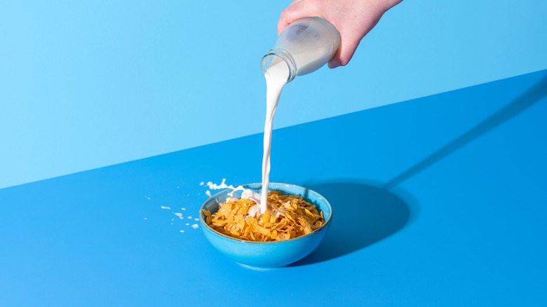 pouring milk into cereal bowl