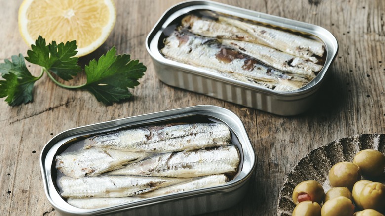 Canned sardines on wood board