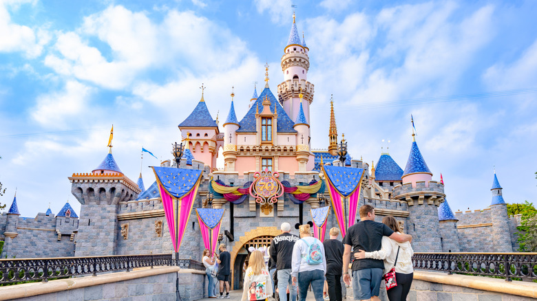 People walking in front of a Disneyland castle in Anaheim