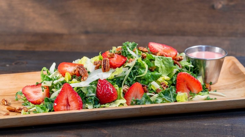 Strawberry pecan salad on a wooden tray at Disneyland