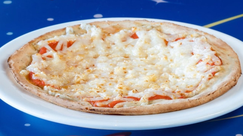 Vegan cheese pizza on a white plate at Disneyland