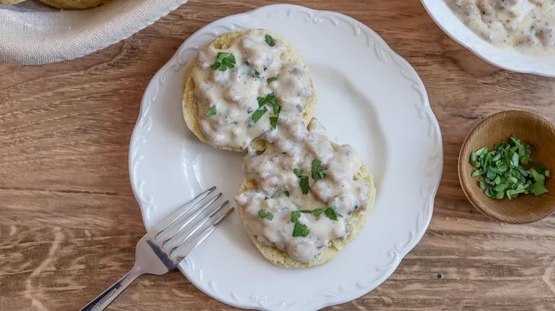 Biscuits and Herbed Sausage Gravy on white plate with fork