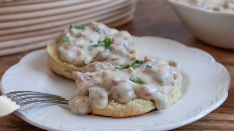 Biscuits and Herbed Sausage Gravy on white plate with fork