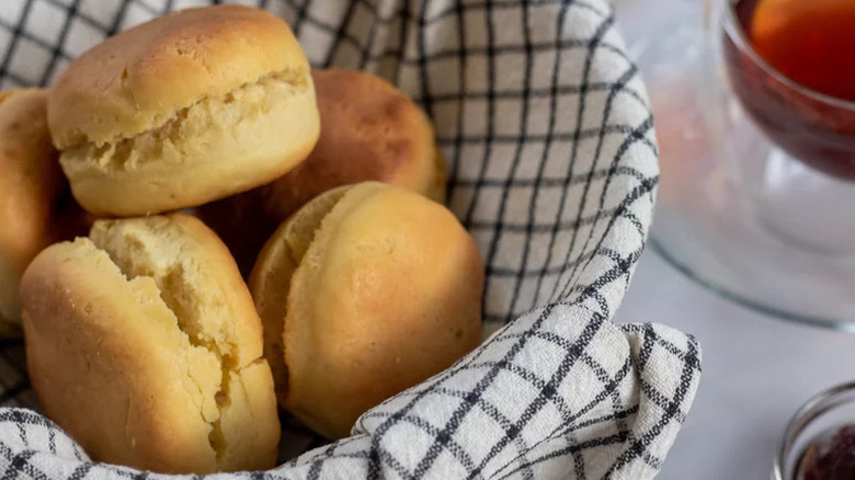 Simple Fluffy Sourdough Biscuits in towel-lined bowl