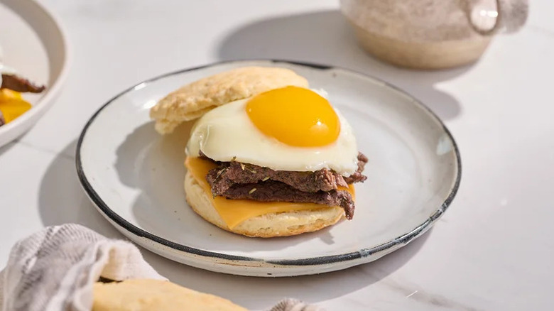 Steak and Cheese Biscuit Sandwich on white plate