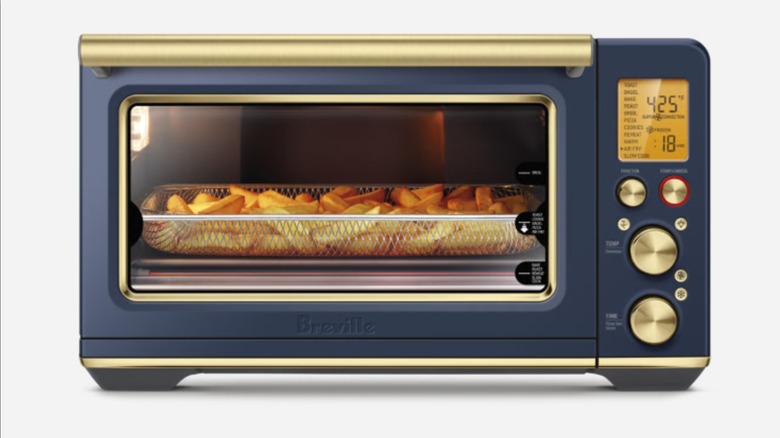 A blue and gold Breville Smart Oven with chips air frying