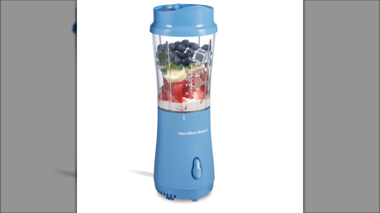A blue Hamilton Beach blender full of fruit