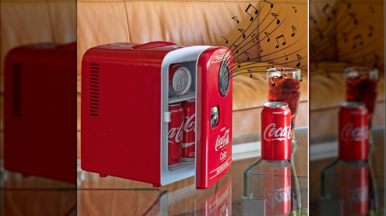 A red Coca-Cola fridge playing music