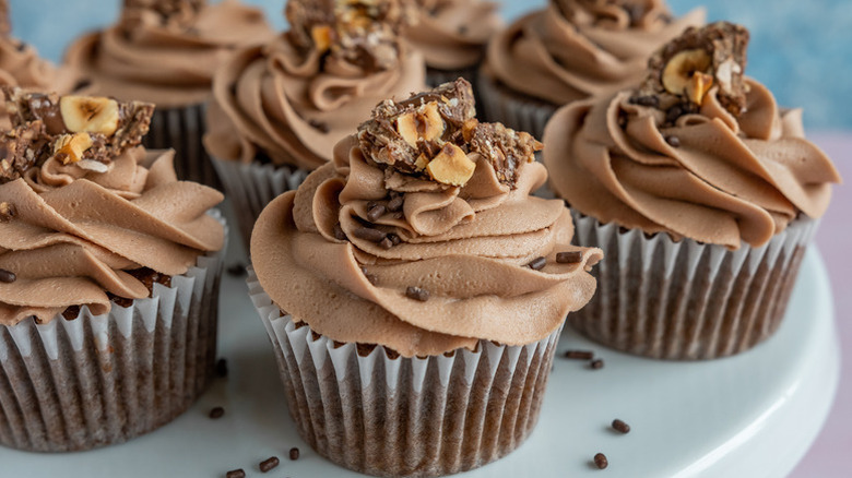 Nutella cupcakes on plate, topped with chocolate hazelnut candies