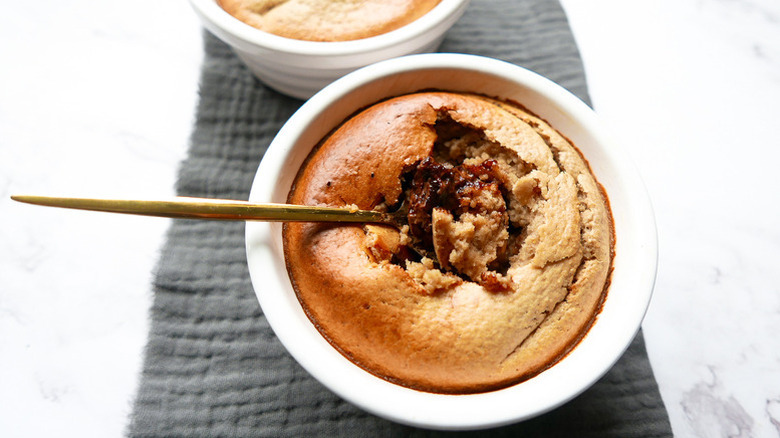 Nutella baked oats in white ramekin with spoon