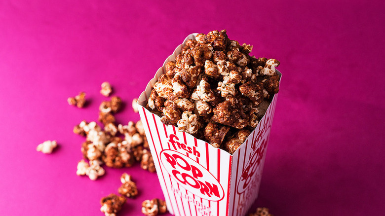 Nutella-covered popcorn in striped cardboard carton
