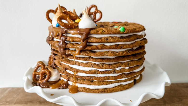 Giant cookie cake stack topped with pretzels and marshmallow kisses
