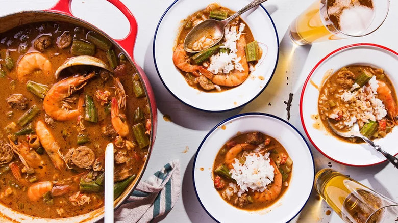 Aerial shot of gumbo in a pot and several bowls