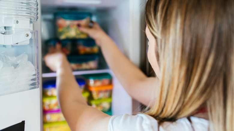 woman getting frozen meal from freezer