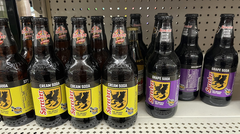 Glass bottles and cans of craft sodas