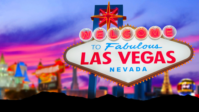 Las Vegas sign with strip behind it.