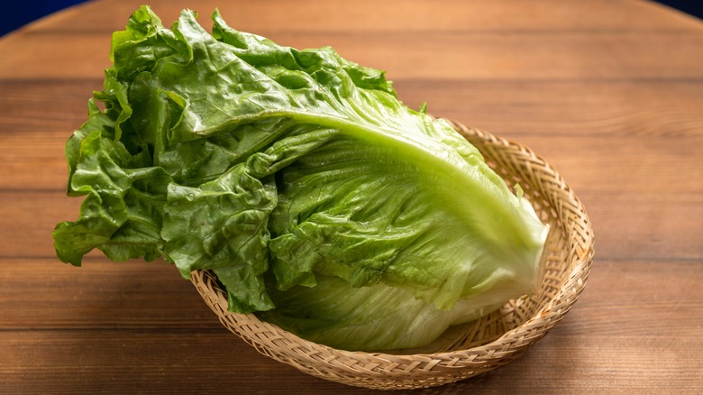 A romaine lettuce in a small basket with its core being shown