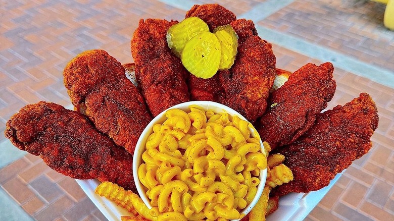 Hot breaded chicken tenders with sides of mac and cheese and crinkle fries