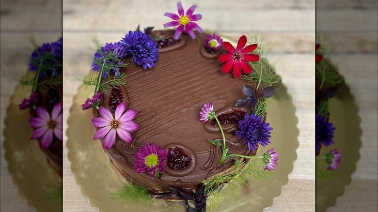 Top view of chocolate cake decorated with flowers