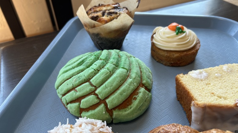 Concha, carrot cake, and muffin on tray