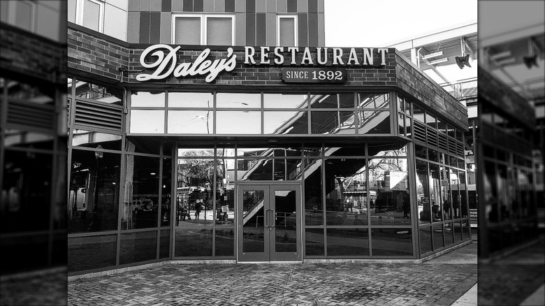 Black and white image of the entrance to the new Daley's