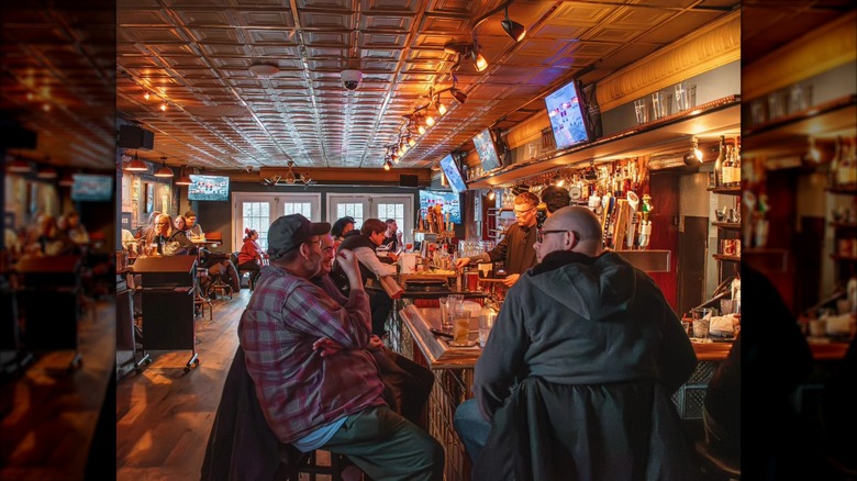 Customers at and around the bar at the Fireside