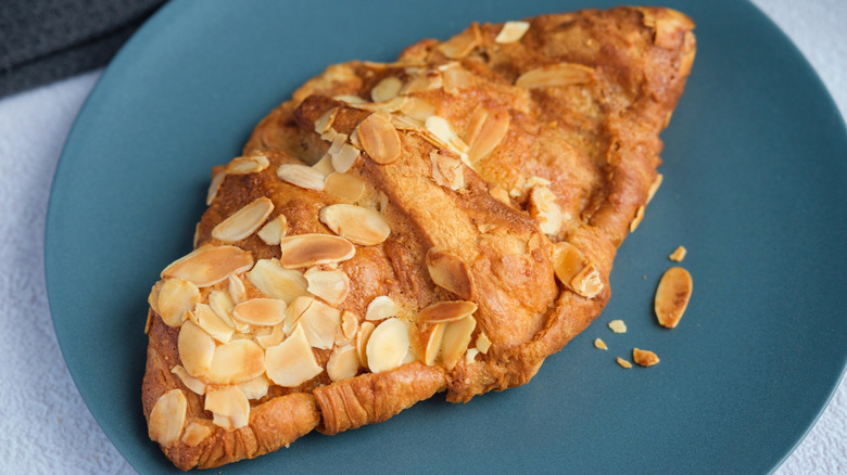 Almond croissant on blue plate