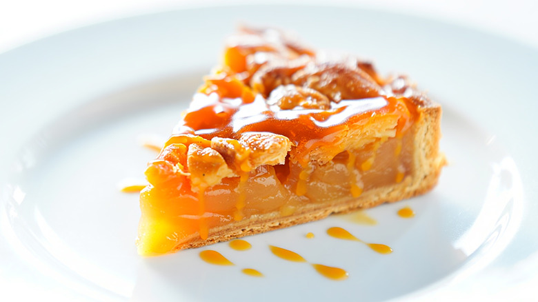 Piece of tarte Tatin on white plate