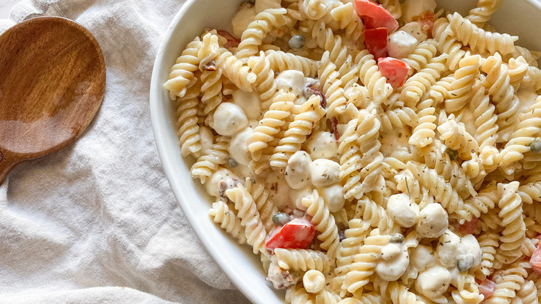 Creamy sun-dried tomato and mozzarella pasta in serving dish