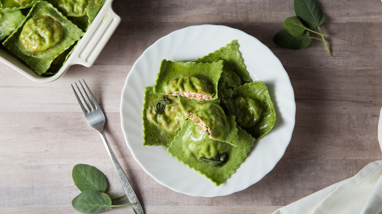 Spinach ravioli served from baking dish onto plate